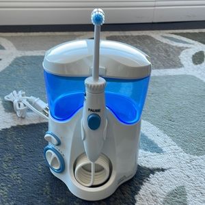 New! Waterpik water flosser. Opened box but never used.